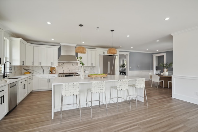 433 Belden Hill Rd, Wilton, CT 06897 - kitchen featuring stainless steel appliances, wall chimney exhaust hood, a sink, crown molding, and a kitchen island