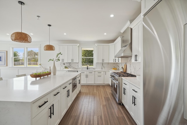 433 Belden Hill Rd, Wilton, CT 06897 - kitchen with stainless steel appliances, a sink, light countertops, backsplash, and white cabinetry