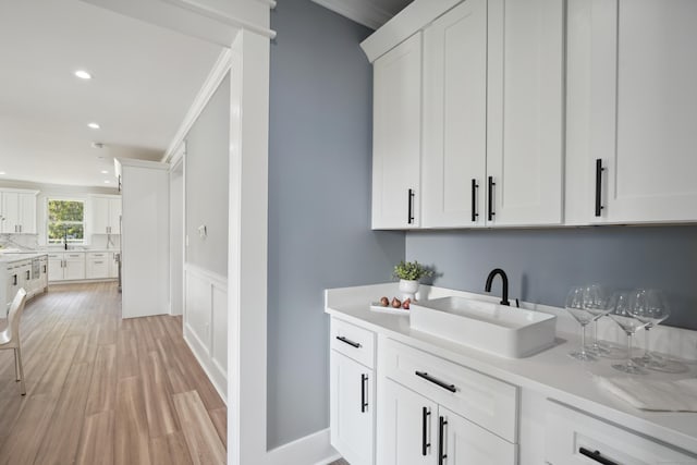 433 Belden Hill Rd, Wilton, CT 06897 - bar with a sink, recessed lighting, light wood-type flooring, decorative backsplash, and wainscoting