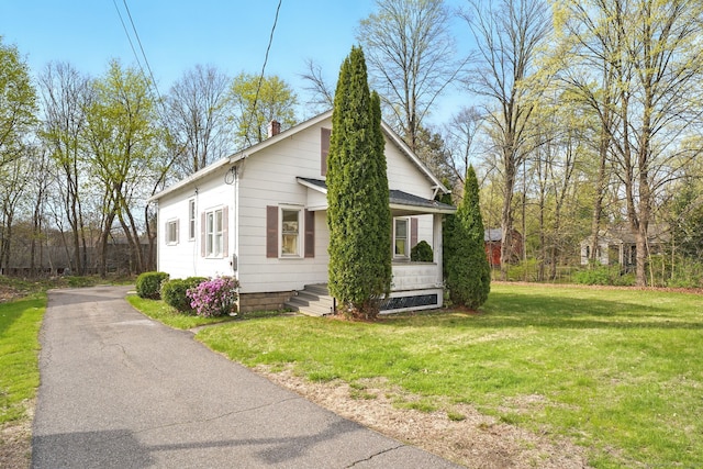 576 Main St, Somers, CT 06071 - view of home's exterior featuring a lawn and a chimney