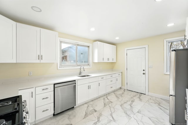 576 Main St, Somers, CT 06071 - kitchen featuring appliances with stainless steel finishes, light countertops, marble finish floor, a sink, and white cabinetry