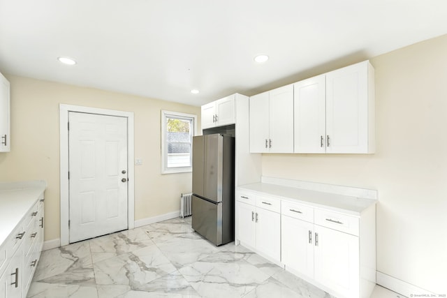 576 Main St, Somers, CT 06071 - kitchen featuring radiator, marble finish floor, white cabinetry, baseboards, and freestanding refrigerator