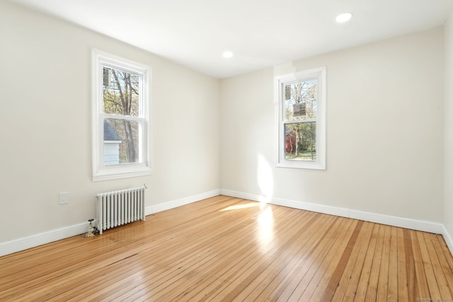 576 Main St, Somers, CT 06071 - unfurnished room with baseboards, recessed lighting, radiator heating unit, and light wood-type flooring