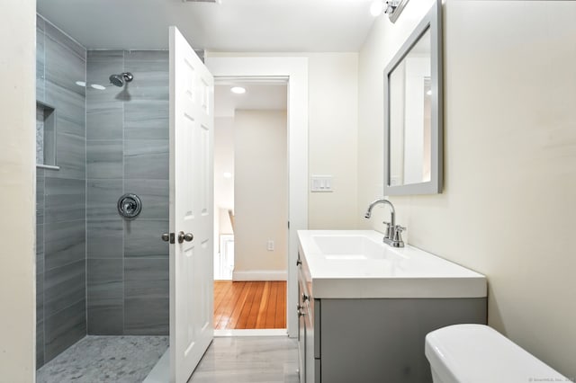 576 Main St, Somers, CT 06071 - full bathroom with a tile shower, toilet, recessed lighting, wood finished floors, and vanity