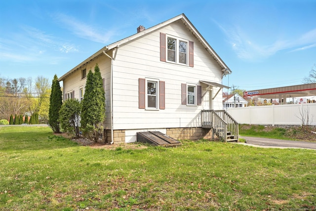576 Main St, Somers, CT 06071 - view of front facade with fence, a chimney, and a front yard