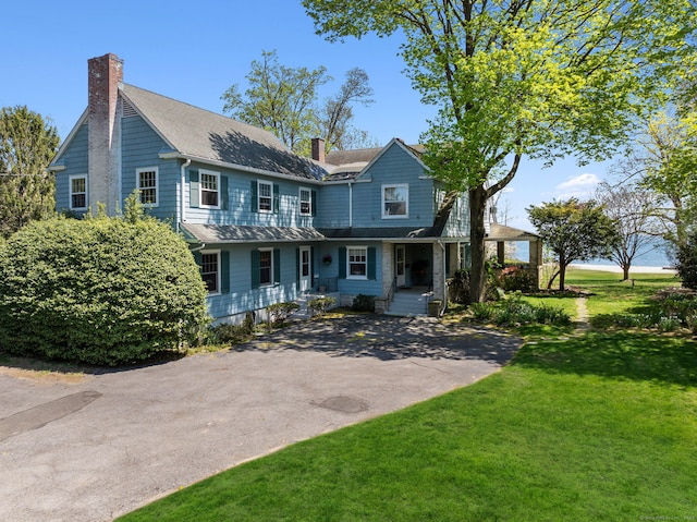 86 Wallacks Dr, Stamford, CT 06902 - view of front facade featuring a chimney, covered porch, a front lawn, and a shingled roof