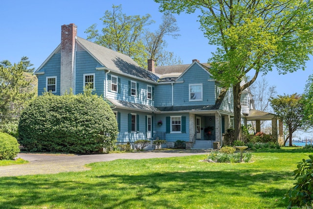 86 Wallacks Dr, Stamford, CT 06902 - view of front of property with a chimney, a standing seam roof, a front yard, metal roof, and roof with shingles