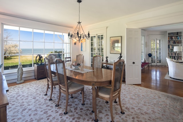 86 Wallacks Dr, Stamford, CT 06902 - dining space featuring a chandelier, wood finished floors, crown molding, and healthy amount of natural light