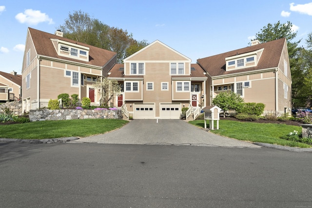 75 Brittania Rd Unit 75, Danbury, CT 06811 - view of front facade featuring an attached garage, a chimney, a front yard, and aphalt driveway