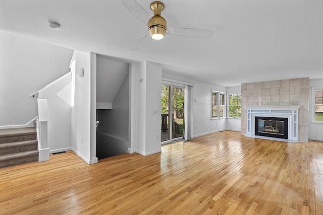 75 Brittania Rd Unit 75, Danbury, CT 06811 - unfurnished living room featuring baseboards, light wood finished floors, ceiling fan, and stairway