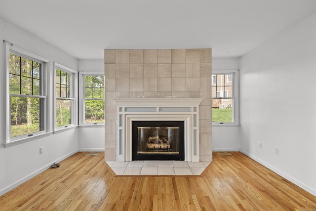 75 Brittania Rd Unit 75, Danbury, CT 06811 - details with baseboards, visible vents, wood finished floors, and a tile fireplace