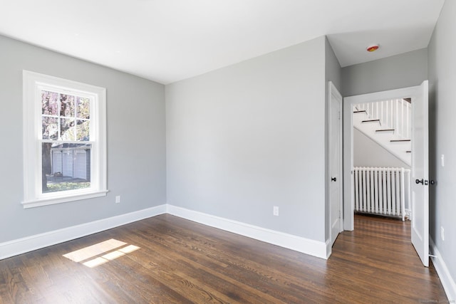 60 Mill St, New Britain, CT 06051 - unfurnished bedroom featuring radiator, baseboards, and dark wood finished floors