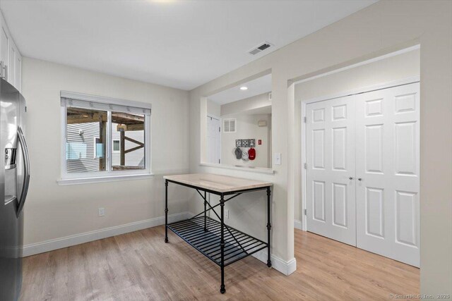 interior space featuring baseboards, visible vents, and light wood-style flooring