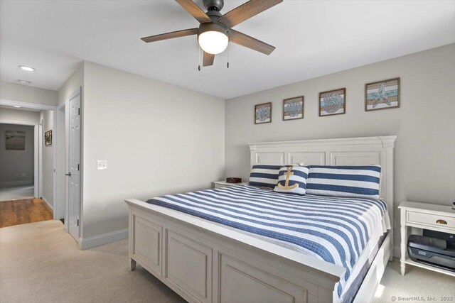 bedroom with baseboards, ceiling fan, recessed lighting, and light colored carpet