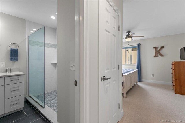 full bathroom with vanity, baseboards, recessed lighting, a walk in shower, and a ceiling fan