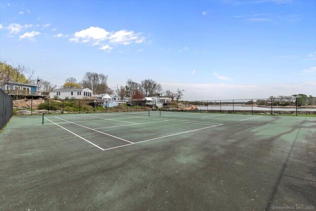 view of tennis court featuring fence