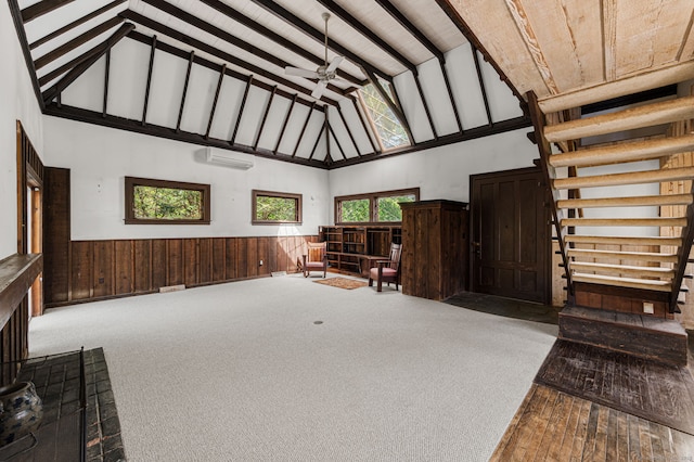 302 Ferry Rd, Old Lyme, CT 06371 - carpeted living area with high vaulted ceiling, wainscoting, wood walls, a wall mounted air conditioner, and beam ceiling
