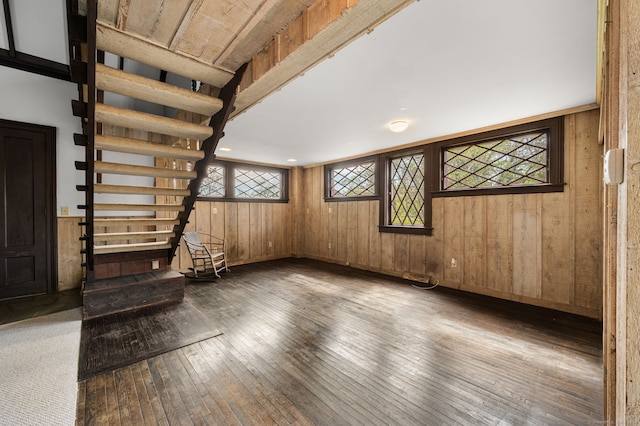 302 Ferry Rd, Old Lyme, CT 06371 - empty room featuring wood-type flooring, wooden walls, plenty of natural light, and stairs