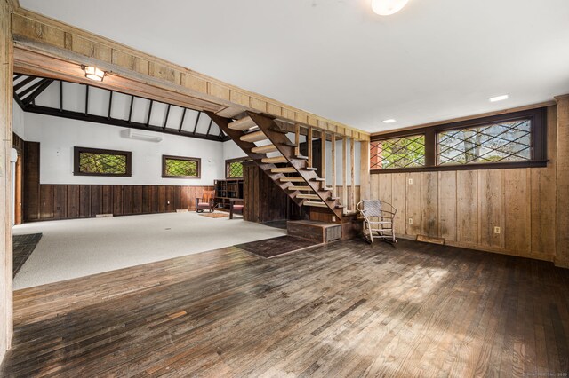 302 Ferry Rd, Old Lyme, CT 06371 - unfurnished living room with wooden walls, stairs, hardwood / wood-style flooring, plenty of natural light, and wainscoting