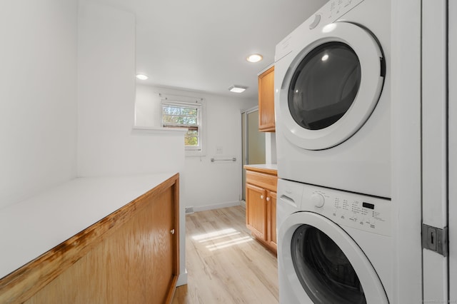 302 Ferry Rd, Old Lyme, CT 06371 - laundry area featuring stacked washer / drying machine, light wood-style floors, recessed lighting, and baseboards