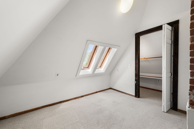 302 Ferry Rd, Old Lyme, CT 06371 - additional living space featuring a skylight, lofted ceiling, carpet flooring, and baseboards