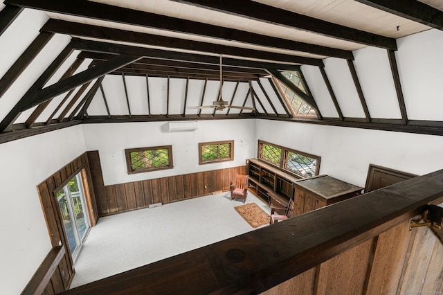 302 Ferry Rd, Old Lyme, CT 06371 - living room featuring a wall mounted AC, beamed ceiling, high vaulted ceiling, carpet, and wood walls