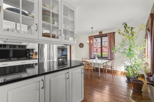 55-69 Sawmill Rd, Branford, CT 06405 - kitchen featuring dark countertops, white cabinets, wood finished floors, and stainless steel appliances
