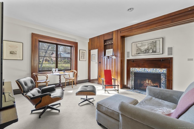 55-69 Sawmill Rd, Branford, CT 06405 - carpeted living area with baseboards, wood walls, and a fireplace