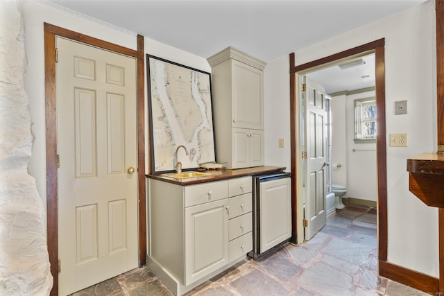 55-69 Sawmill Rd, Branford, CT 06405 - bathroom featuring stone finish floor, vanity, toilet, and baseboards