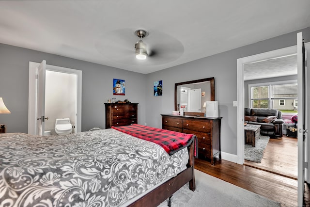 bedroom with baseboards, a ceiling fan, and dark wood finished floors