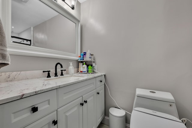 bathroom featuring toilet and vanity