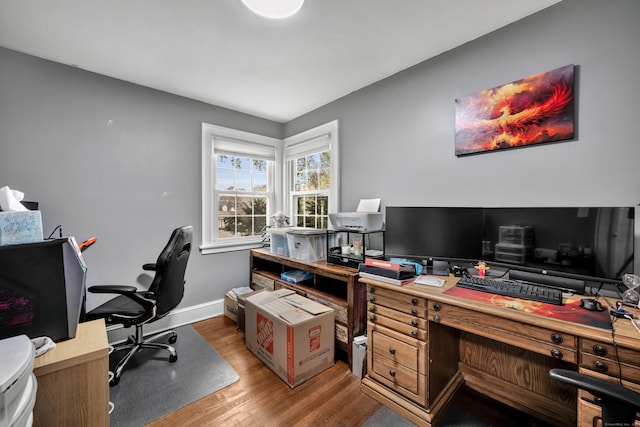 home office featuring baseboards and wood finished floors