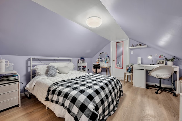 bedroom featuring light wood-type flooring and lofted ceiling