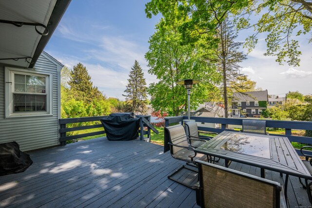 wooden terrace with outdoor dining area