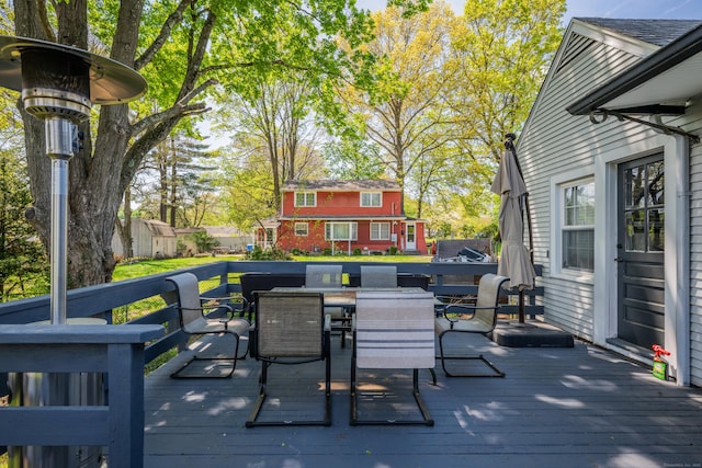 wooden terrace featuring outdoor dining space