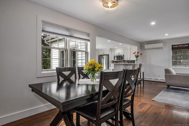 dining room featuring a baseboard radiator, plenty of natural light, a wall mounted AC, and dark wood finished floors