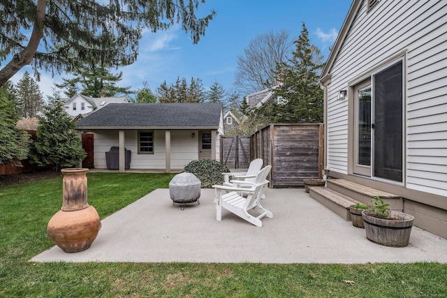 view of patio featuring fence and an outdoor structure