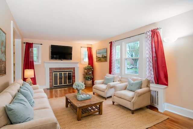20 Fairview St, Simsbury, CT 06070 - living area with a fireplace, baseboards, a healthy amount of sunlight, and wood finished floors