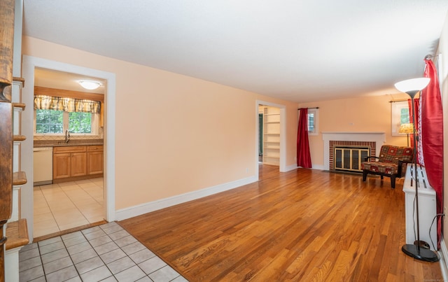 20 Fairview St, Simsbury, CT 06070 - living area with a brick fireplace, baseboards, and light wood-style floors
