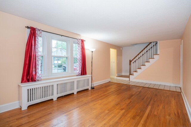 20 Fairview St, Simsbury, CT 06070 - interior space with baseboards, radiator, stairs, and wood finished floors