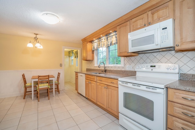 20 Fairview St, Simsbury, CT 06070 - kitchen with a sink, white appliances, an inviting chandelier, decorative backsplash, and wainscoting