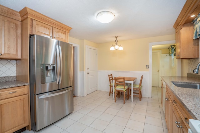 20 Fairview St, Simsbury, CT 06070 - kitchen featuring wainscoting, a sink, stainless steel fridge, a chandelier, and backsplash