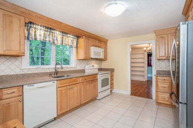 20 Fairview St, Simsbury, CT 06070 - kitchen with a sink, tasteful backsplash, white appliances, light stone counters, and light tile patterned flooring