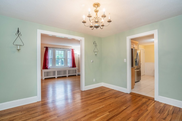 20 Fairview St, Simsbury, CT 06070 - unfurnished dining area with radiator, a notable chandelier, light wood-type flooring, and baseboards