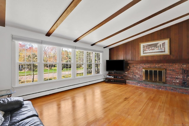 unfurnished living room featuring a brick fireplace, wood finished floors, a baseboard radiator, wooden walls, and lofted ceiling with beams