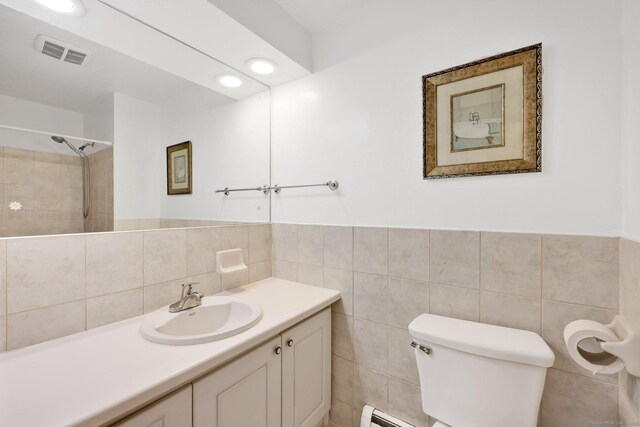 full bathroom with visible vents, vanity, toilet, and tile walls