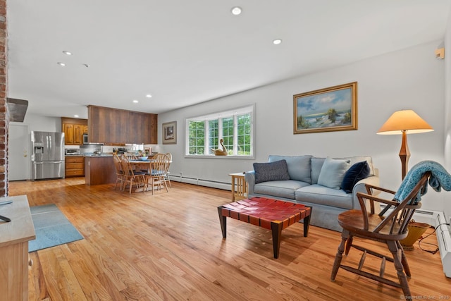 living area with recessed lighting, light wood finished floors, and baseboard heating