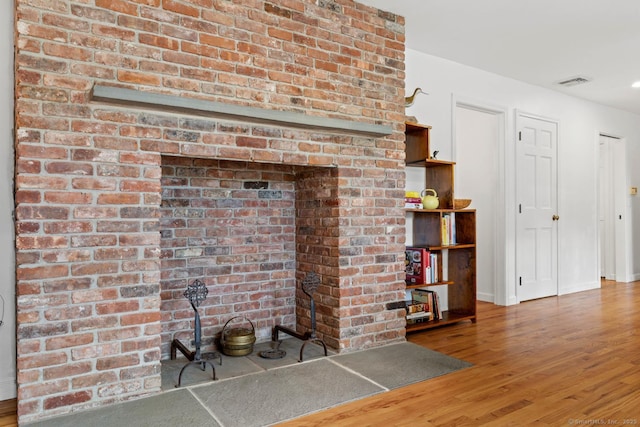 room details with baseboards, visible vents, and wood finished floors