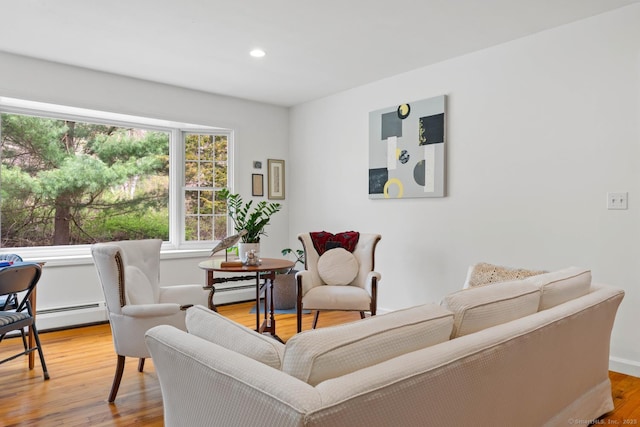 sitting room with baseboards, recessed lighting, and wood finished floors