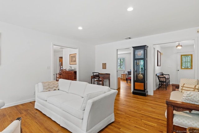 living area featuring visible vents, recessed lighting, and light wood finished floors